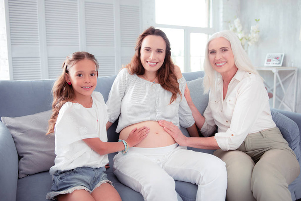 Pregnant woman feeling happy spending time with her family - Foto, Imagem