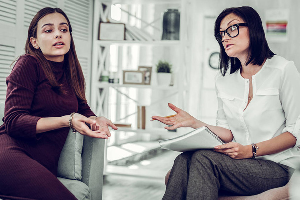 Dark-haired psychologist giving some instructions to her client - Fotoğraf, Görsel