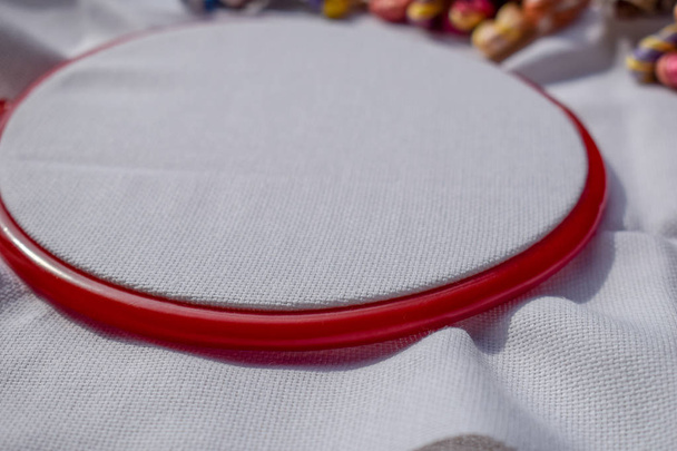 The embroidery hoop with canvas and bright sewing threads. - Photo, Image