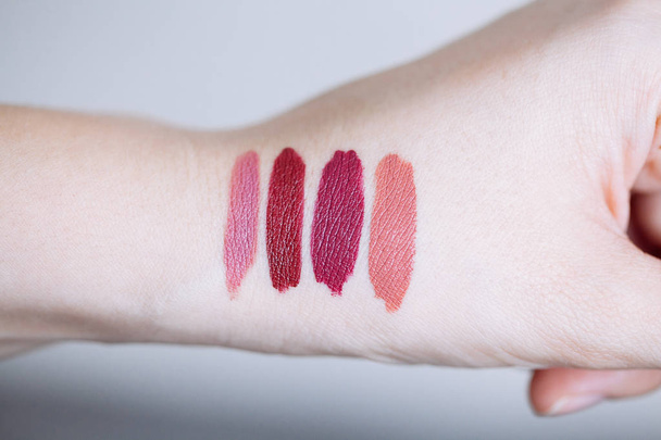 Female arm with lipstick tone color and testing different lipsti - Fotografie, Obrázek