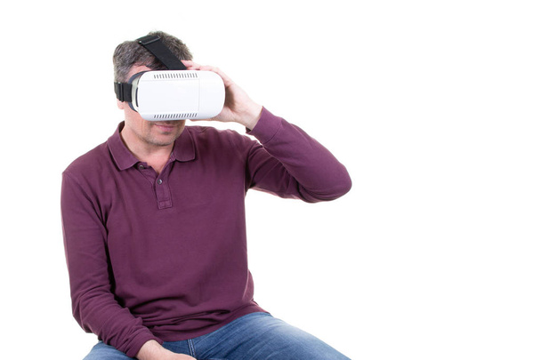 Closeup of male young man wearing virtual reality goggles smartphone using with VR headset in office Horizontal - Photo, image