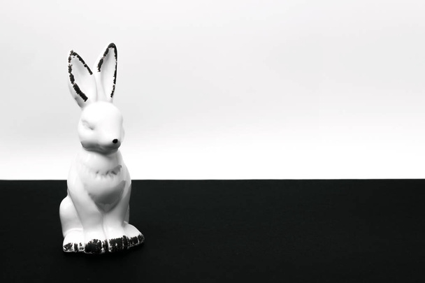 ceramic figurine Easter bunny rabbit on a white black background - Photo, Image