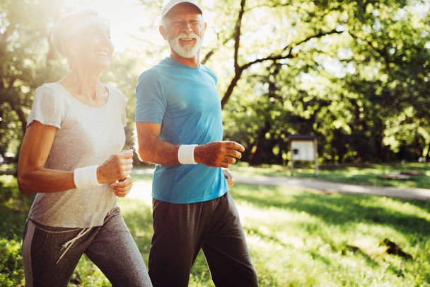 Happy senior people jogging to stay helathy and lose weight - Zdjęcie, obraz