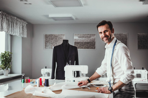 Tailor over work desk during work, fashion designer at workshop - Foto, Imagem