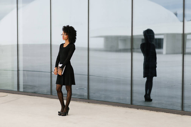 Modern stylish professional woman standing against city corporate building. - Fotografie, Obrázek