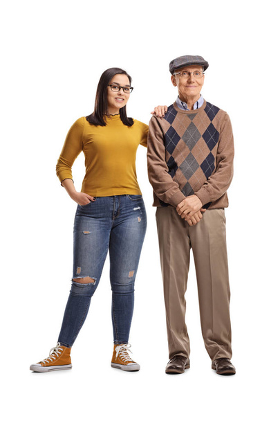 Full length portrait of a teenage granddaughter and grandfather posing isolated on white background - Photo, Image