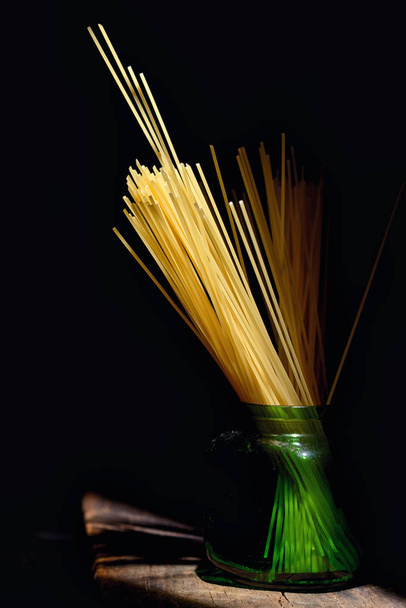 Italian spaghetti on black background - Φωτογραφία, εικόνα