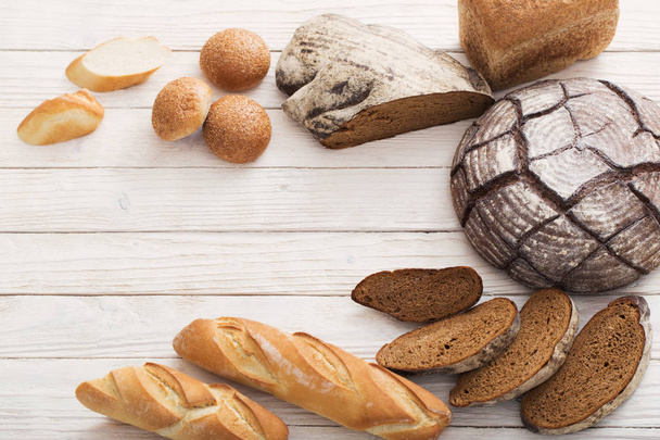 different types of bread on wooden background - Fotoğraf, Görsel
