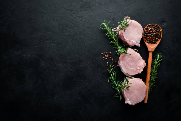 Raw meat, medallions with rosemary and spices. On a white wooden background. Top view. Free copy space. - Foto, Imagem
