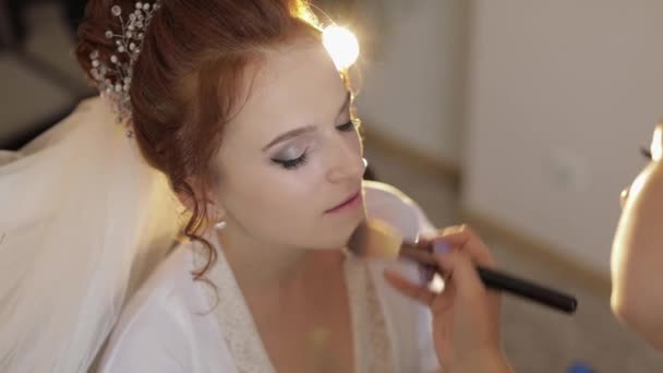 Wedding makeup artist making a make up for bride in veil. Beautiful sexy model - Footage, Video