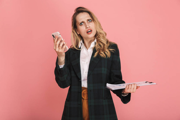 Photo of displeased businesswoman holding clipboard and talking  - Fotoğraf, Görsel