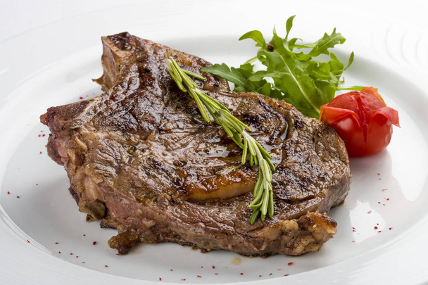  Ribeye Steak with rosemary. On a white plate - Photo, Image