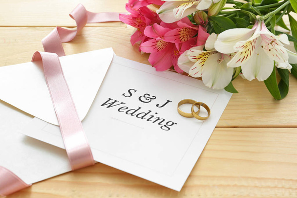 Wedding invitation, rings and flowers on table - Photo, Image