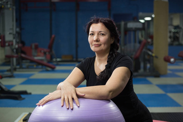 Senior woman in gym with fitball. close-up. copy space. - Fotó, kép