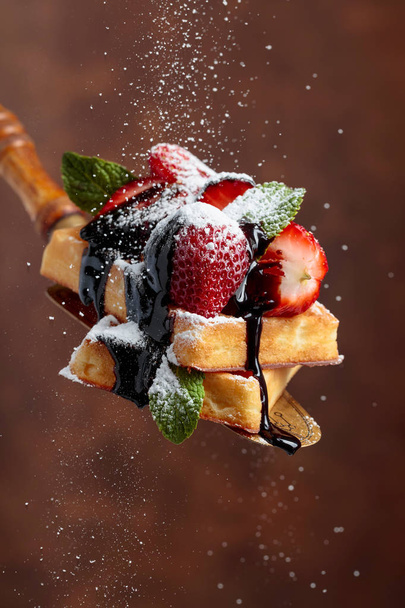 Belgian waffles with strawberries, mint and chocolate sauce. - Photo, Image
