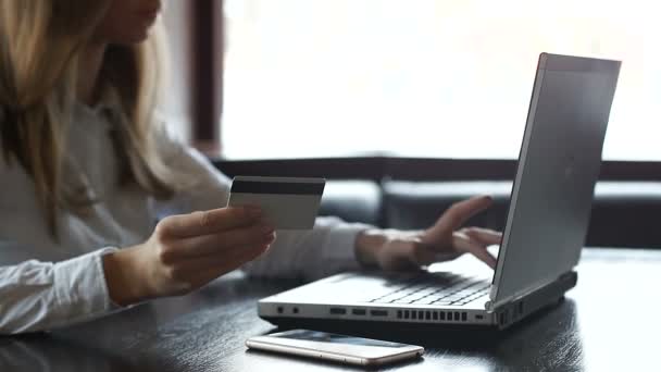Lady holding credit card and typing on laptop, online shopping in web store - Πλάνα, βίντεο
