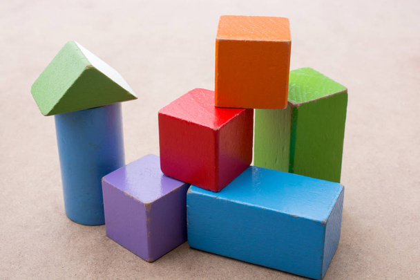 Colorful building  blocks on brown background - Фото, зображення