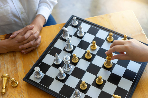 Two businesswoman thinking and hold king chess - Zdjęcie, obraz