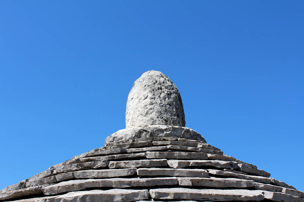 Traditional stone tiles structure top Kazun under clear blue sky on a warm sunny day - Photo, Image