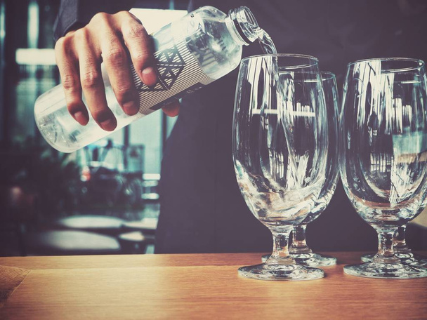 Verter la bebida de agua en el vaso
 - Foto, imagen