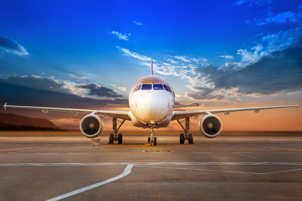 современный самолет на аэродроме против заката
 - Фото, изображение