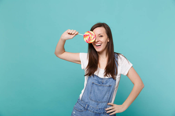 Portrait of cheerful young woman in denim clothes holding, cover - Photo, image