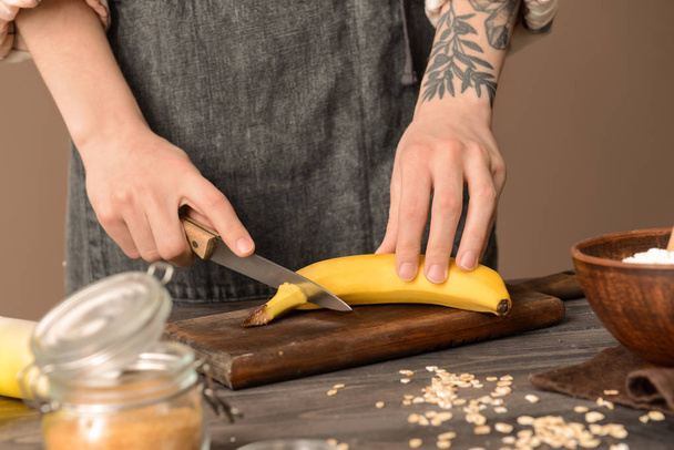 Woman preparing tasty banana bread at table - Фото, зображення