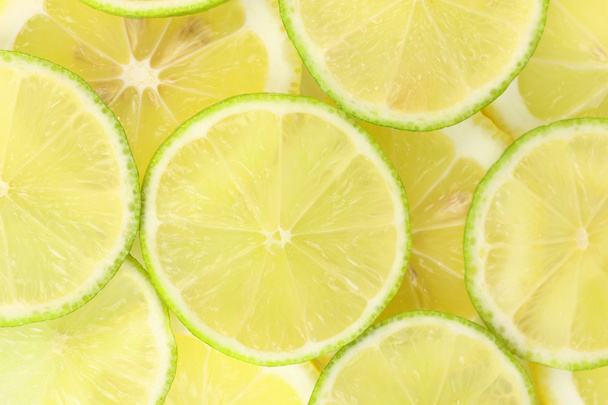 Lime and lemon slices background - Foto, afbeelding