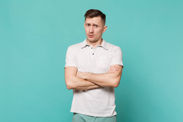 Portrait of perplexed young man in casual clothes standing, hold - Foto, Imagem