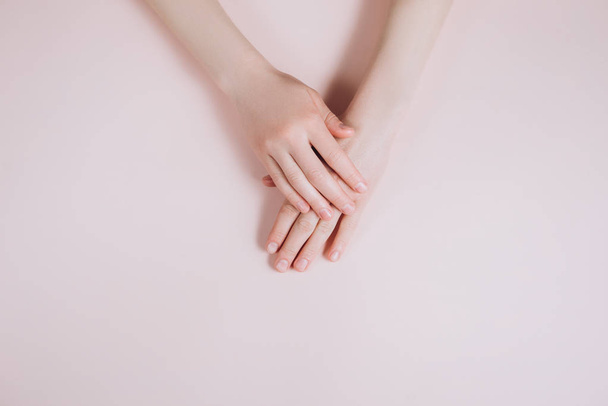 Beautiful Woman Hands with copy space on a beige background. Beauty cosmetic research and development concept. Top view - Photo, Image