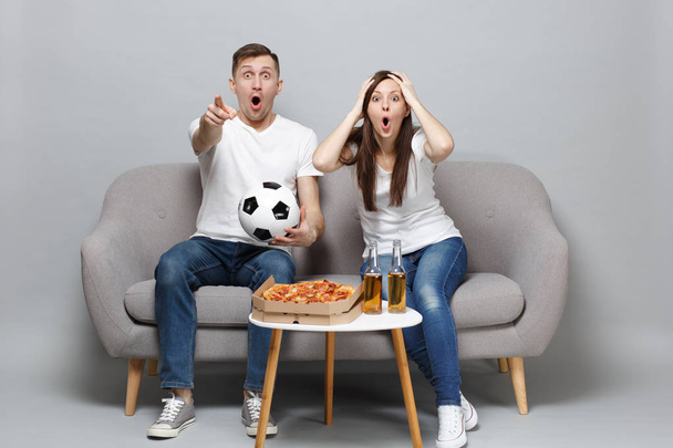 Shocked couple woman man football fans cheer up support favorite - Foto, afbeelding
