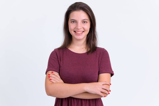 Portrait of happy young beautiful woman smiling with arms crossed - Photo, image