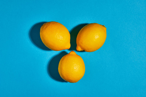 Lemon on blue background. Flat lay, top view, copy space . Food concept. - Photo, Image