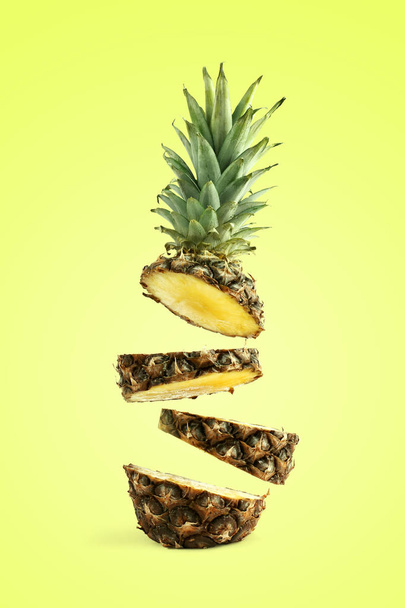 Pineapple sliced, levitates in the air. Concept of summer mood on a yellow background. - Foto, afbeelding