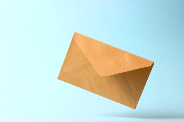 The envelope falls to the ground on a colored background. - Photo, Image