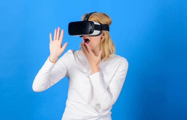 The woman with glasses of virtual reality. Beautiful woman wearing virtual reality goggles in studio. Woman with virtual reality headset. VR devices. - Фото, зображення