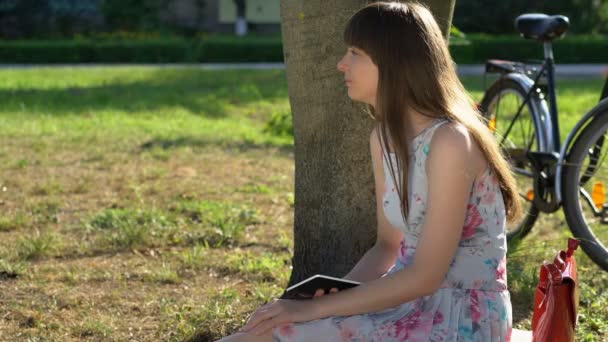 Young beautiful woman daydreaming in park, thinking about future, fallen in love - Séquence, vidéo