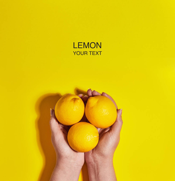 Creative layout made of lemon in hand on yellow background. Flat lay, top view, copy space . Food concept. - Фото, изображение