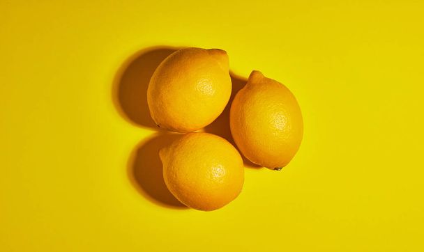 Lemon on yellow background. Flat lay, top view, copy space . Food concept. - Photo, Image