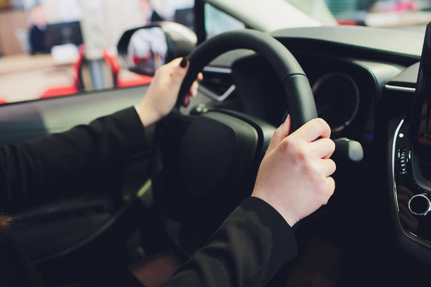 Woman driving a car, hands on steering wheel close-up. - Photo, Image