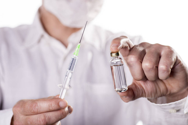 Doctor with syringe and vaccine - Fotoğraf, Görsel