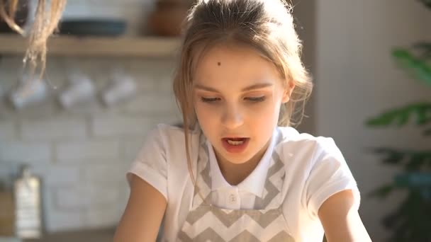 Sisters cooking. Litlle kid girl teaching how to knead dough. Hands in the dough. - Materiał filmowy, wideo