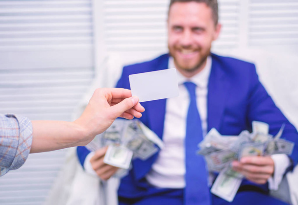 Smiling businessman with bundle of american dollar cash money at office. Pay card. Business, people, success and fortune concept. - Fotoğraf, Görsel