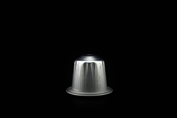 Espresso coffee capsule or coffee pod on black background. Isolated. - Photo, Image