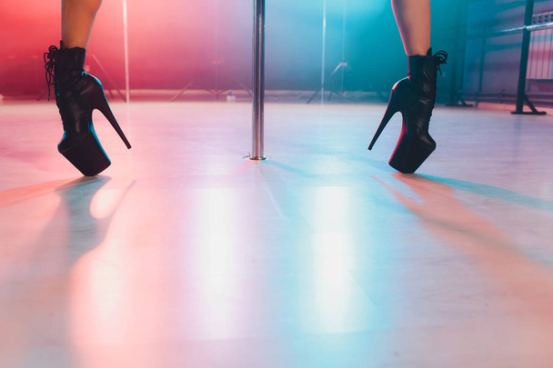 young striptease dancer moving in high heels shoes on stage in strip night club, Pole dancing. - Zdjęcie, obraz