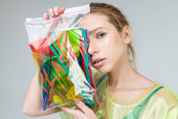 Appealing model with natural makeup posing with plastic - Foto, Imagem