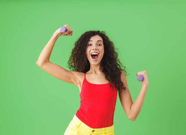 Portrait of brunette girl doing sports and lifting weights again - Valokuva, kuva