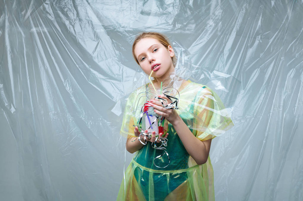 Model working for environmental organization posing with plastic - Foto, afbeelding