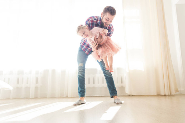 Father teaches to dance his cute little daughter. - Valokuva, kuva