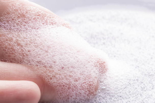 Foam on hand with bubbles - Photo, Image